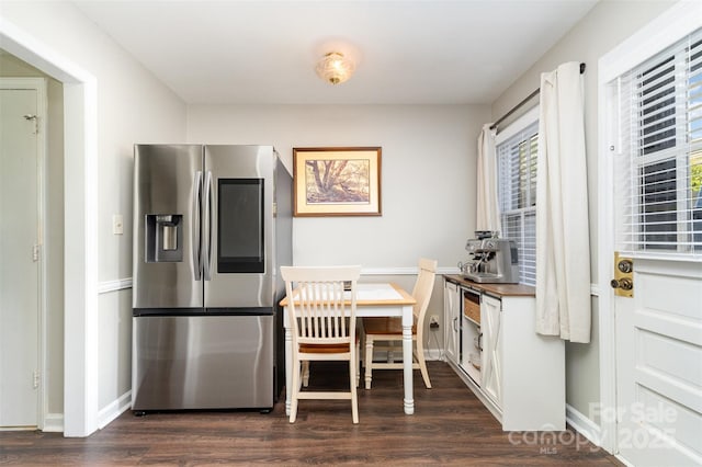 dining room featuring baseboards and dark wood-style floors