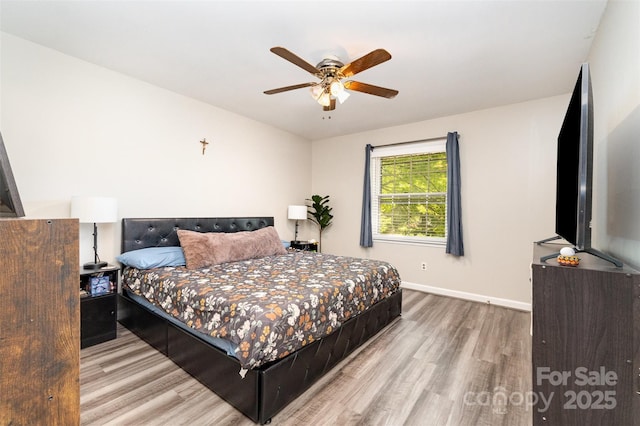 bedroom with baseboards, a ceiling fan, and wood finished floors