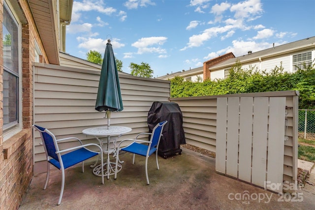 view of patio / terrace with grilling area and fence