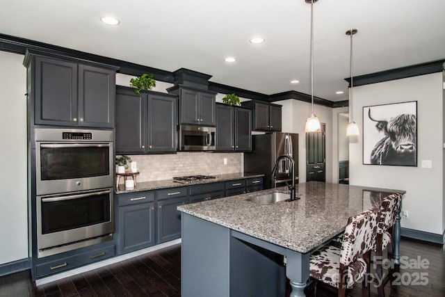 10707 Charmont Pl, Huntersville, NC 28078 - kitchen featuring stainless steel appliances, a sink, a kitchen island with sink, decorative backsplash, and stone counters