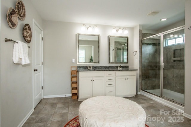 10707 Charmont Pl, Huntersville, NC 28078 - bathroom featuring a shower stall, baseboards, and double vanity