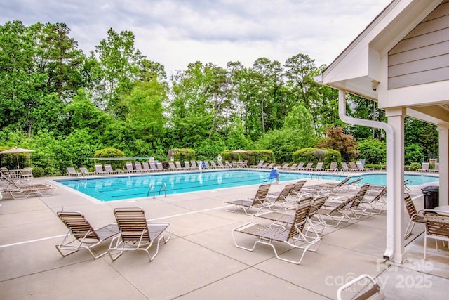 10707 Charmont Pl, Huntersville, NC 28078 - community pool featuring fence, view of wooded area, and a patio area
