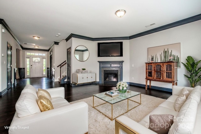 10707 Charmont Pl, Huntersville, NC 28078 - living room featuring crown molding, dark wood-style floors, baseboards, stairway, and a glass covered fireplace