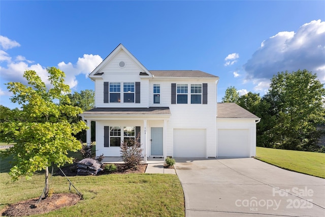 traditional-style home with a garage, a front lawn, covered porch, and concrete driveway