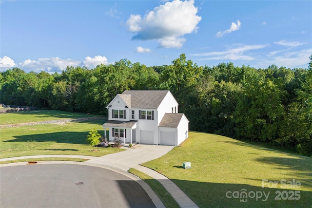 view of front facade featuring a forest view, an attached garage, driveway, and a front lawn