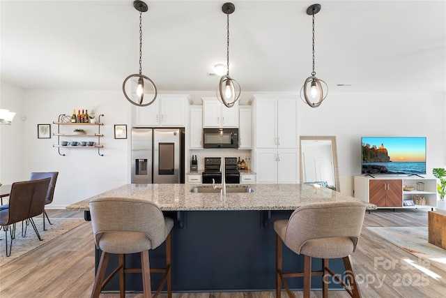 548 Dutch White Dr, Clover, SC 29710 - kitchen with black appliances, a sink, light wood-style flooring, and white cabinetry