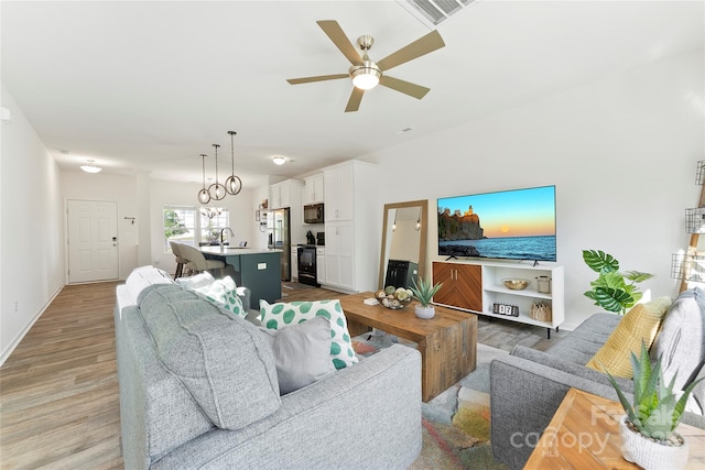 548 Dutch White Dr, Clover, SC 29710 - living room featuring light wood-type flooring, ceiling fan, and baseboards