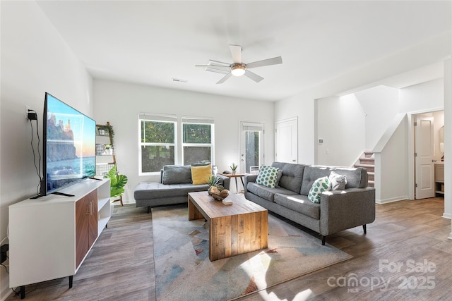 548 Dutch White Dr, Clover, SC 29710 - living room featuring wood finished floors, a ceiling fan, stairs, and baseboards