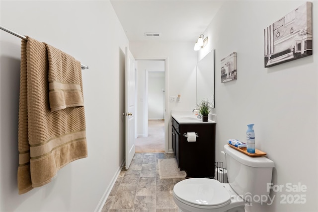 548 Dutch White Dr, Clover, SC 29710 - bathroom featuring stone finish floors, toilet, vanity, and baseboards