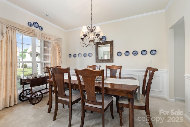 dining area with an inviting chandelier, crown molding, light colored carpet, and visible vents