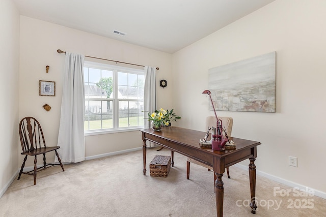 office area featuring baseboards, light carpet, and visible vents