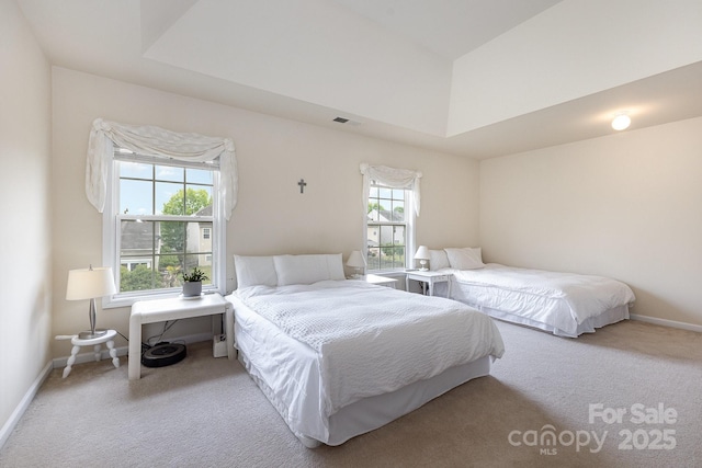 bedroom featuring carpet floors, visible vents, and multiple windows