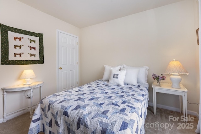bedroom featuring baseboards and carpet