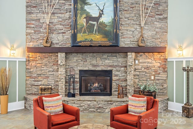 living room featuring stone finish flooring and a stone fireplace