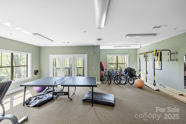 recreation room featuring baseboards, carpet flooring, and visible vents