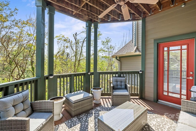 deck with an outdoor living space and ceiling fan