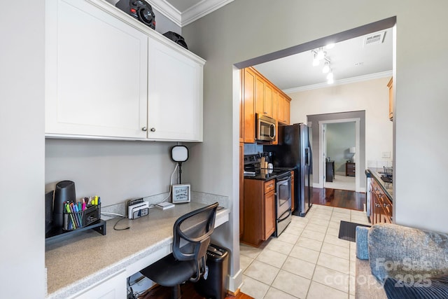 kitchen with electric range, stainless steel microwave, ornamental molding, and built in study area