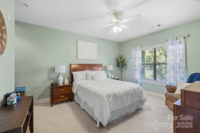 bedroom with baseboards, visible vents, light colored carpet, and ceiling fan