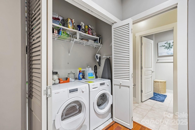 clothes washing area with washer and dryer and laundry area