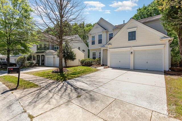 traditional-style house featuring driveway and a garage
