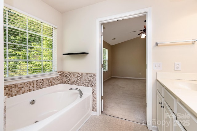 full bathroom with a bath, baseboards, a ceiling fan, and vanity