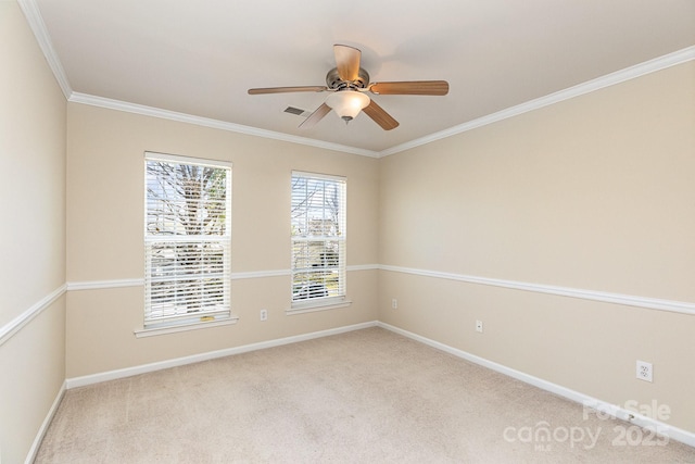 empty room with ornamental molding, baseboards, carpet flooring, and ceiling fan