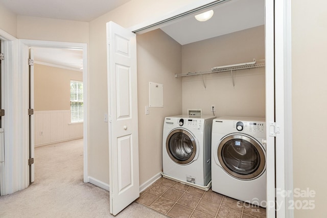 laundry room with washer and dryer, light carpet, a wainscoted wall, and laundry area