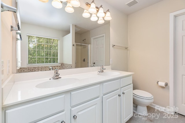 full bathroom featuring visible vents, a sink, a shower stall, and double vanity