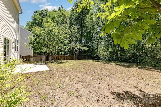 view of yard with fence and a patio