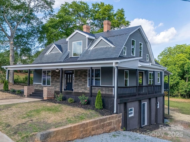view of front of home featuring covered porch and a chimney