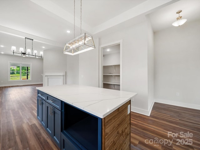 kitchen featuring dark wood-type flooring, blue cabinetry, baseboards, decorative light fixtures, and recessed lighting