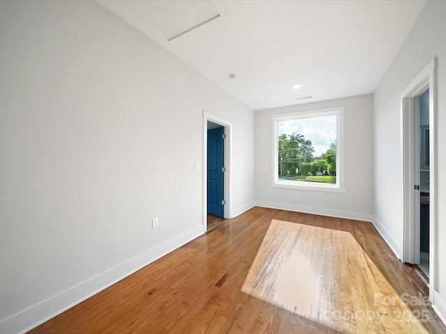 empty room with baseboards and wood finished floors