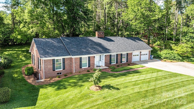 view of front of house with driveway, brick siding, a garage, a chimney, and a front yard