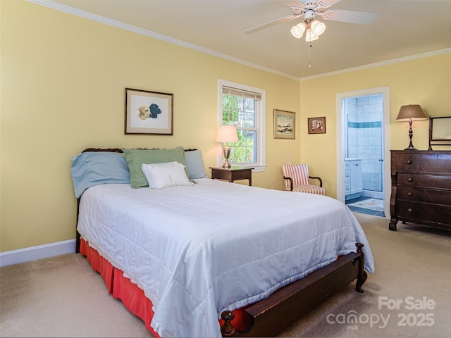 bedroom with carpet floors, crown molding, connected bathroom, baseboards, and a ceiling fan