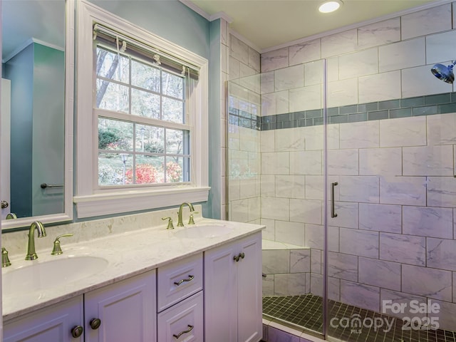 full bathroom featuring a stall shower, crown molding, double vanity, and recessed lighting