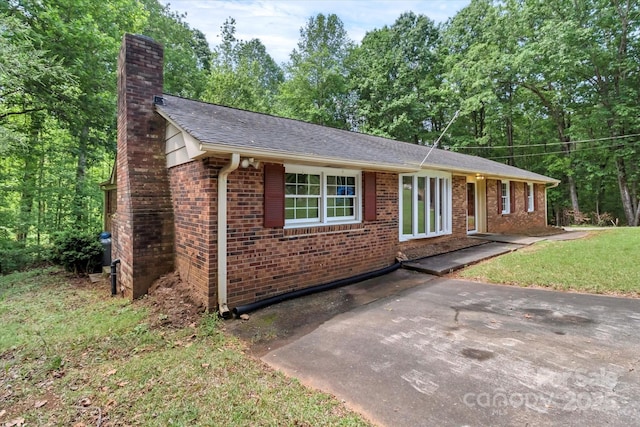 182 Freedom Mill Rd, Gastonia, NC 28052 - single story home with brick siding, roof with shingles, and a chimney
