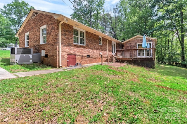 182 Freedom Mill Rd, Gastonia, NC 28052 - back of house with a wooden deck, a yard, central AC, and brick siding