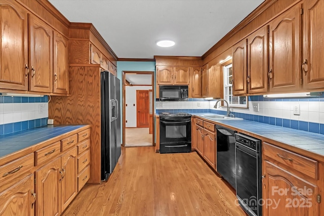 182 Freedom Mill Rd, Gastonia, NC 28052 - kitchen featuring black appliances, a sink, tile countertops, and decorative backsplash