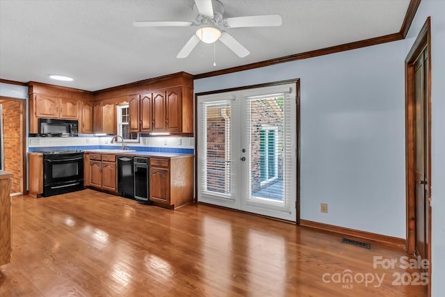 182 Freedom Mill Rd, Gastonia, NC 28052 - kitchen with black appliances, french doors, tasteful backsplash, and ornamental molding