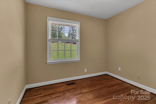 182 Freedom Mill Rd, Gastonia, NC 28052 - empty room featuring visible vents, dark wood finished floors, and baseboards