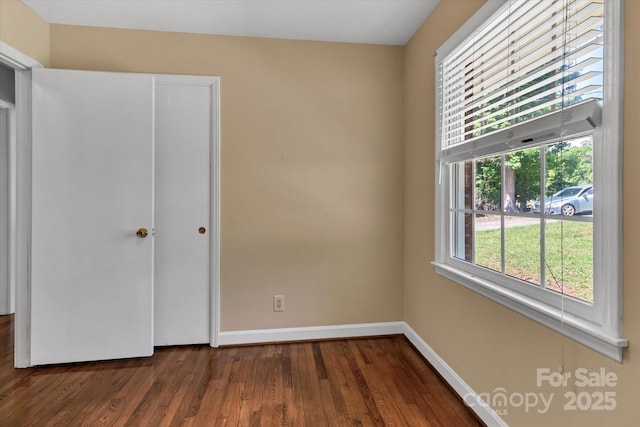 182 Freedom Mill Rd, Gastonia, NC 28052 - unfurnished bedroom featuring dark wood-type flooring, a closet, and baseboards