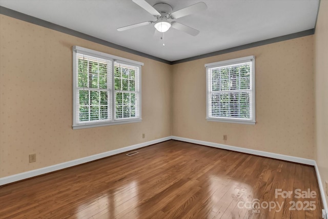 182 Freedom Mill Rd, Gastonia, NC 28052 - empty room with baseboards, visible vents, wood finished floors, and ceiling fan