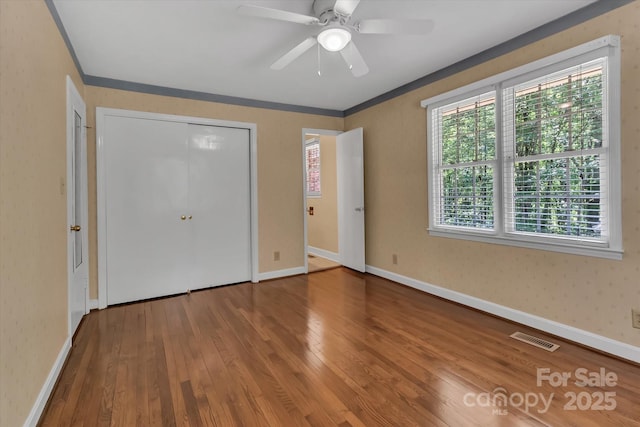 182 Freedom Mill Rd, Gastonia, NC 28052 - unfurnished bedroom featuring baseboards, visible vents, hardwood / wood-style flooring, and ornamental molding