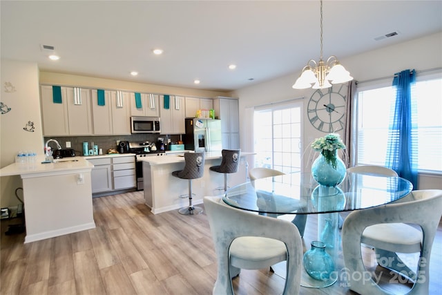 525 San Marco Dr, Gastonia, NC 28056 - dining area with light wood-style flooring, visible vents, an inviting chandelier, and recessed lighting