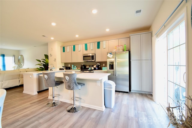 525 San Marco Dr, Gastonia, NC 28056 - kitchen featuring light countertops, visible vents, light wood-style floors, a kitchen island, and appliances with stainless steel finishes