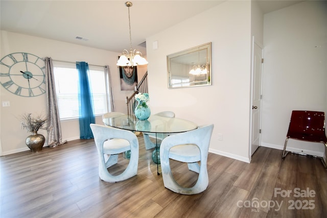 525 San Marco Dr, Gastonia, NC 28056 - dining room with baseboards, wood finished floors, visible vents, and a chandelier