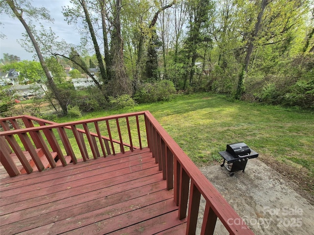 wooden deck featuring a yard