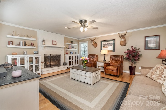 106 S Oakwood Dr, Kings Mountain, NC 28086 - living area featuring light wood-style flooring, baseboards, ceiling fan, a fireplace, and ornamental molding