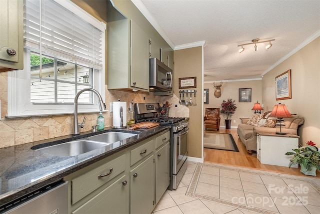 106 S Oakwood Dr, Kings Mountain, NC 28086 - kitchen with stainless steel appliances, a sink, light tile patterned flooring, decorative backsplash, and ornamental molding