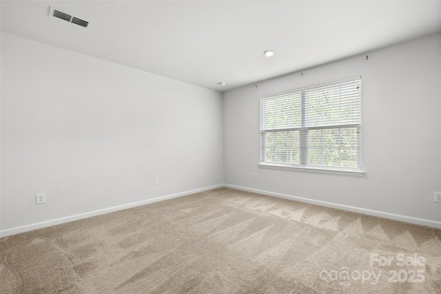 1933 Tin Roof Ln, Monroe, NC 28112 - spare room with baseboards, visible vents, and light carpet